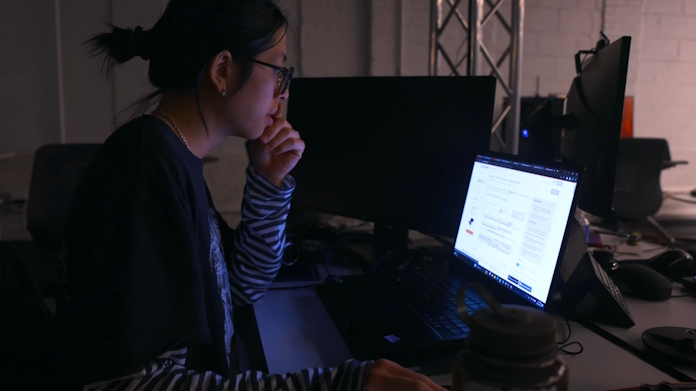 A college student planning a research project using a ProArt Studiobook laptop
