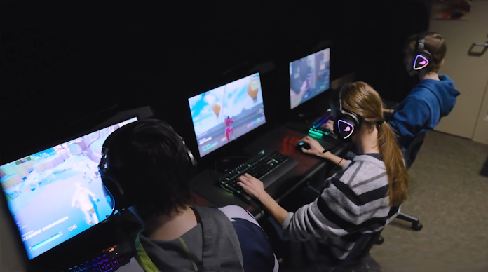 Three students practicing together at the esports lab in Oswego High School