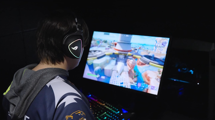 A student playing an esports game using an ROG Delta headset 