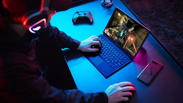 A gamer playing Titanfall 2 using the ROG Flow Z13 gaming laptop with a controller and ROG smartphone nearby