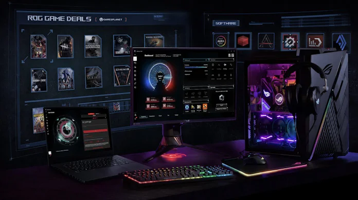 A view of a full gaming PC setup with desktop and laptop with the Armoury Crate app visible on the desktop monitor