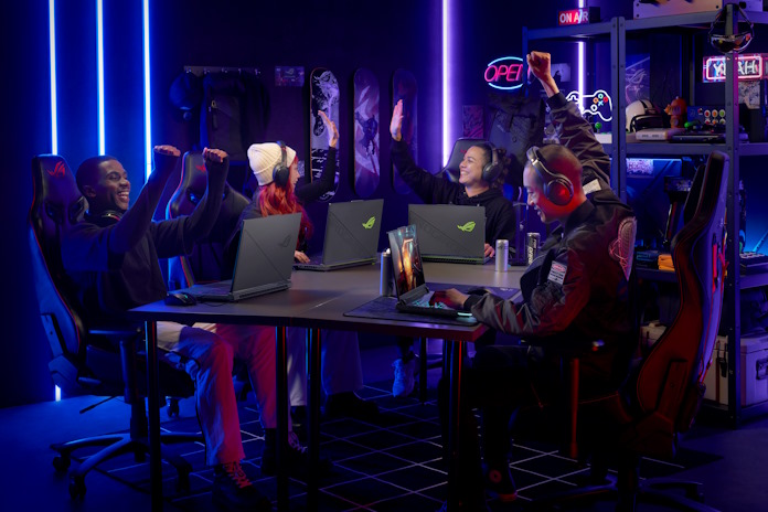 A group of students celebrating together as they play games together using ROG hardware