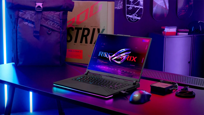 The ROG Strix G16 gaming laptop on a table with an ROG gaming mouse and a backpack 