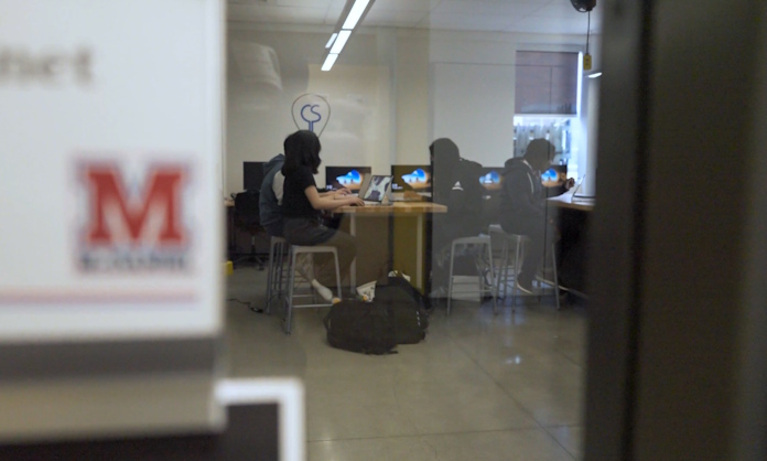 A view of the computer lab at McDaniel High School through a window 