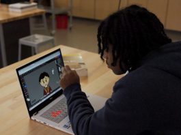 A student at McDaniel High School using the ASUS Chromebook CX34 Flip to develop pixel art with a stylus