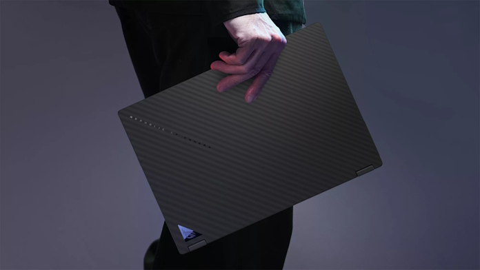 ROG Flow X13 laptop being carried with one hand by a student