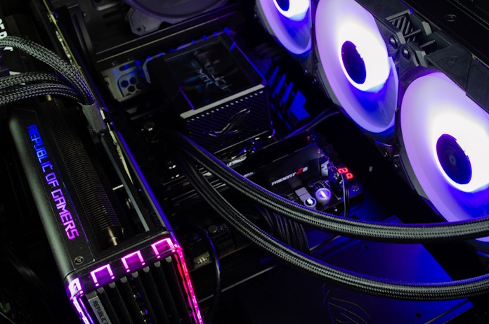 The interior of an ROG gaming PC showing the AIO liquid cooler, graphics card, and motherboard