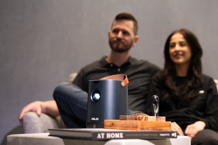 A young couple watching a movie together using the ZenBeam L2 portable projector