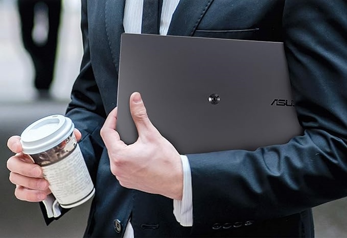 The ZenScreen MB16AH portable monitor in the arm of a businessman walking down the street with a cup of coffee