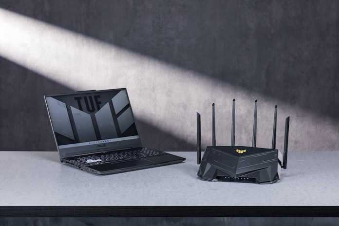 The ROG Rapture GT-AXE16000 router on a desk with other ROG gaming gear