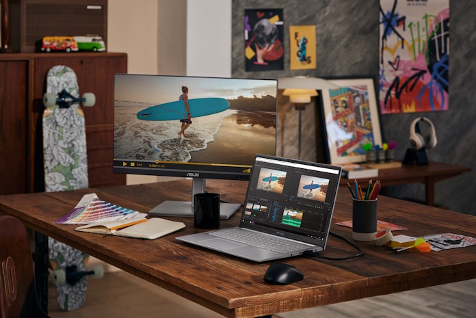 A Vivobook Pro 14 OLED laptop in an artist's studio connected to an ASUS display 