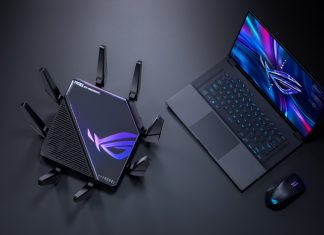 An ROG wireless router, gaming laptop, and mouse on a black surface