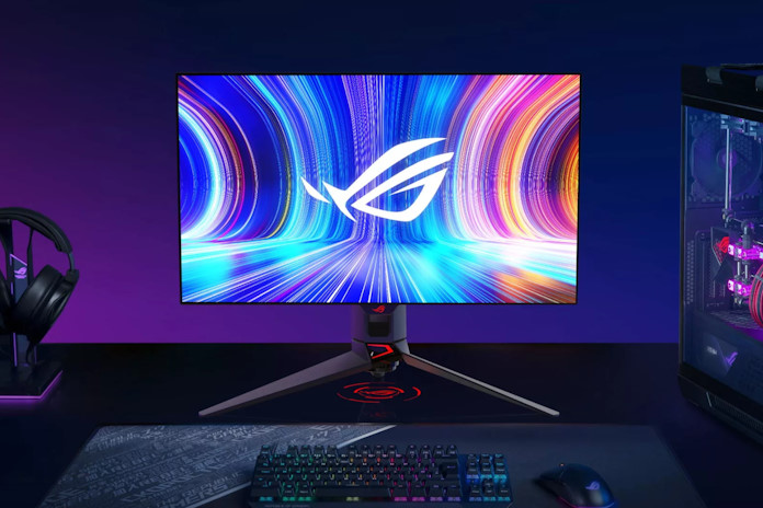 The ROG Swift OLED PG27AQDM gaming monitor on a gaming desk with an ROG desktop PC and peripherals