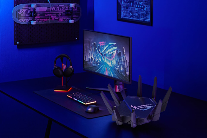 The ROG Rapture GT-AXE16000 router on a desk with other ROG gaming gear