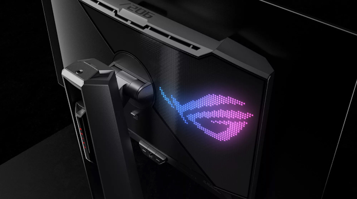 The ROG Swift OLED PG27AQDM gaming monitor on a gaming desk with an ROG desktop PC and peripherals