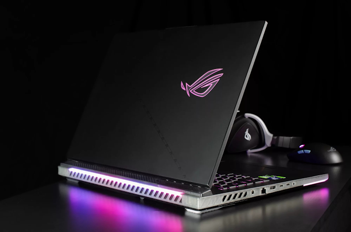 ROG strix SCAR 18 gaming laptop on a table with ROG headset and mouse