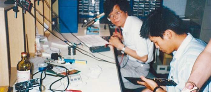 Two ASUS engineers at work on motherboards in 1989