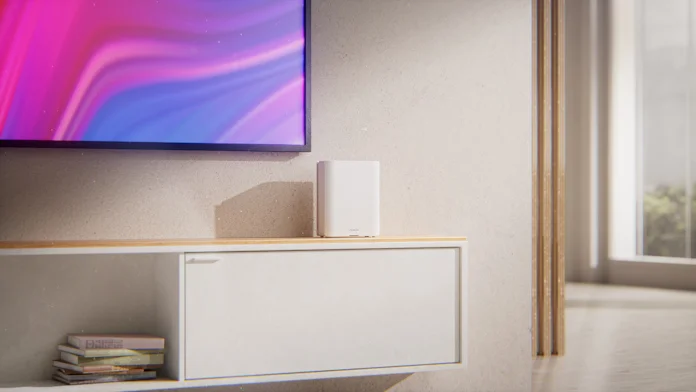 The ZenWiFi BQ16 Pro on an entertainment center beneath a television
