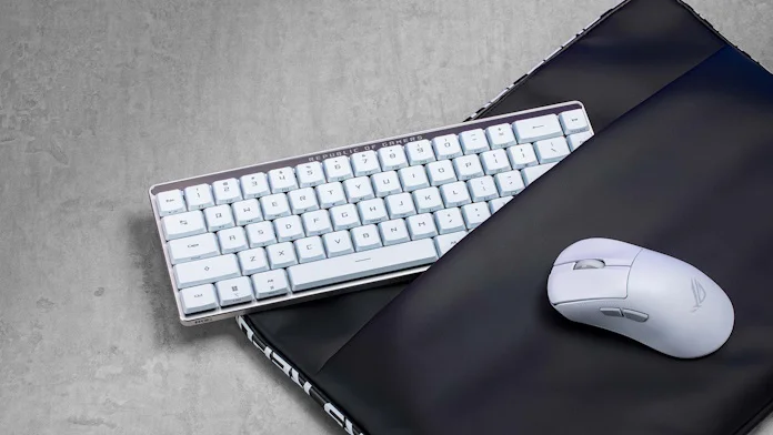 The ROG Falchion RX Low Profile keyboard partially enclosed in an ROG laptop bag next to the ROG Keris II Wireless gaming mouse