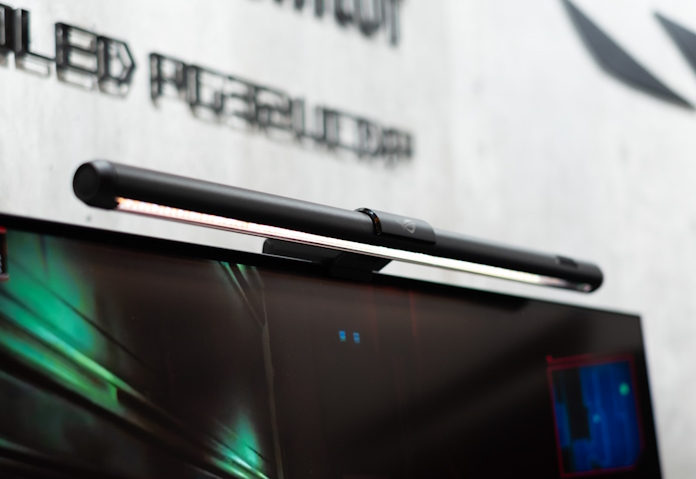A closeup view of the ROG Aura Light Bar mounted on top of an ROG OLED gaming monitor