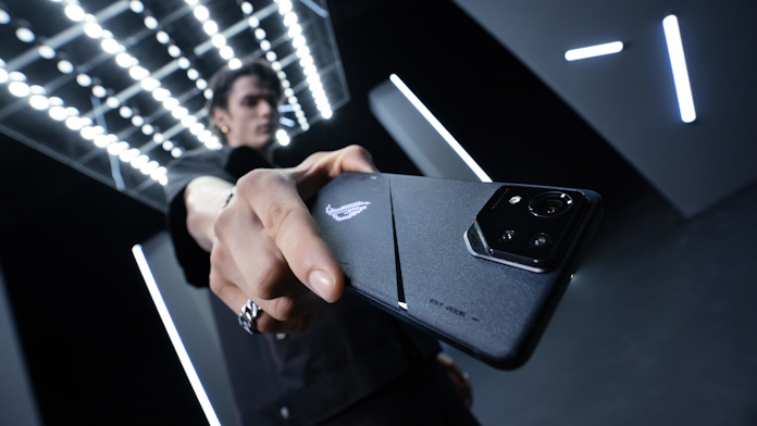 A young man holding the ROG Phone 8 toward the camera