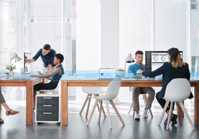 A crowded office space where multiple employees are working using ExpertBook devices