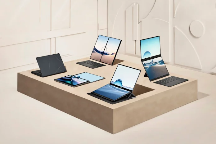 Five Zenbook Duo laptops arranged on a beige table