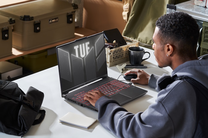 An array of TUF Gaming laptops on a table in a gaming den