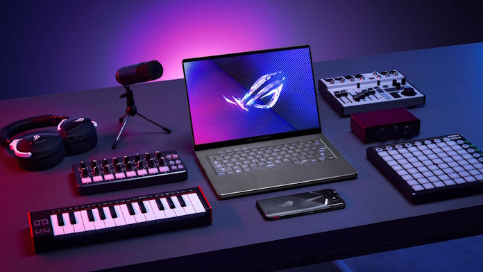 An ROG Zephyrus laptop on a table with tools for music production
