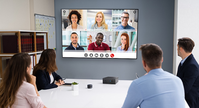 A remote conference in a business setting using an ASUS NUC to drive a large conference room display