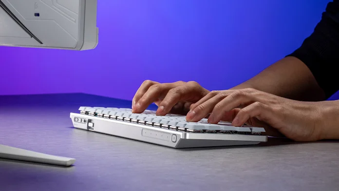 A man typing on the ROG Falchion RX Low Profile keyboard