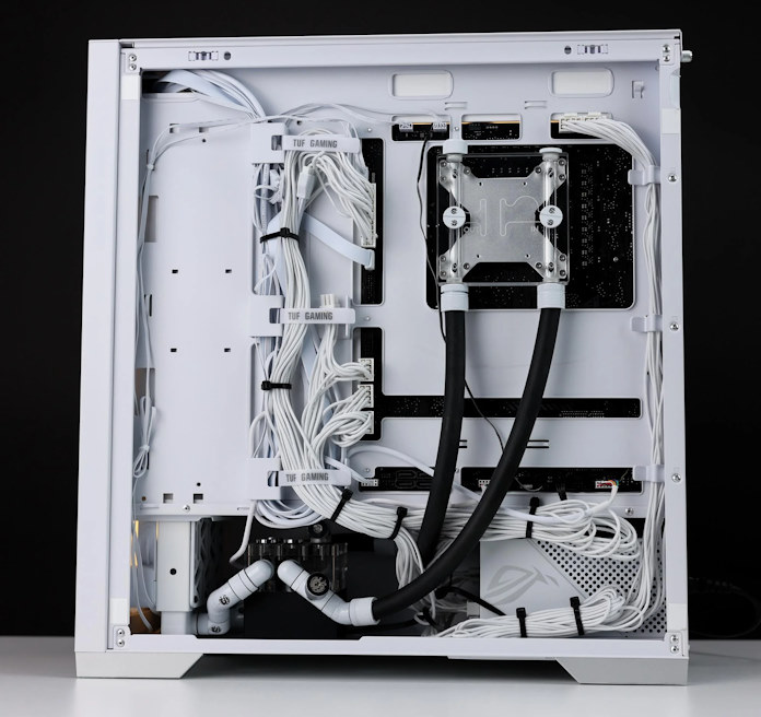 A back view of the cables and tubes routed through the cable management partition of the chassis