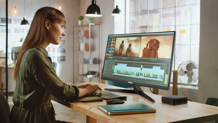 A woman edits a video using a workstation powered by the ASUS NUC 14 Pro 