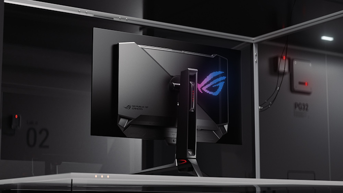 The ROG Swift OLED PG32UCDM gaming monitor on a desk against a cyberpunk background