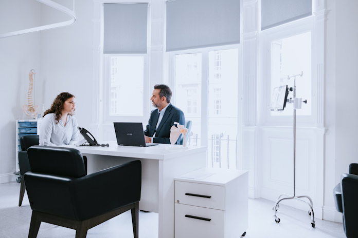 A doctor and patient interacting in a medical office