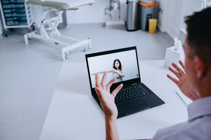 A doctor interacting with a patient in a remote consultation