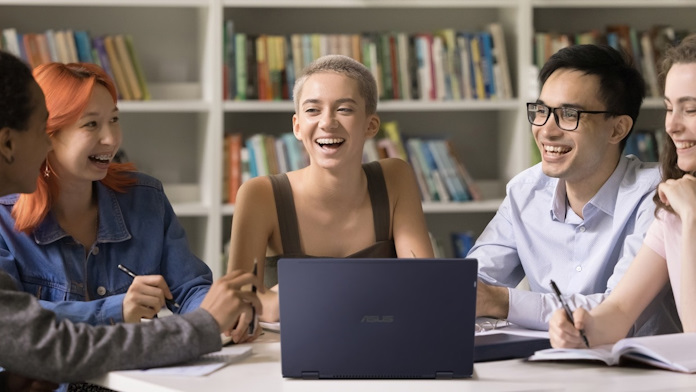 A group of students in a library collaborating on a project 