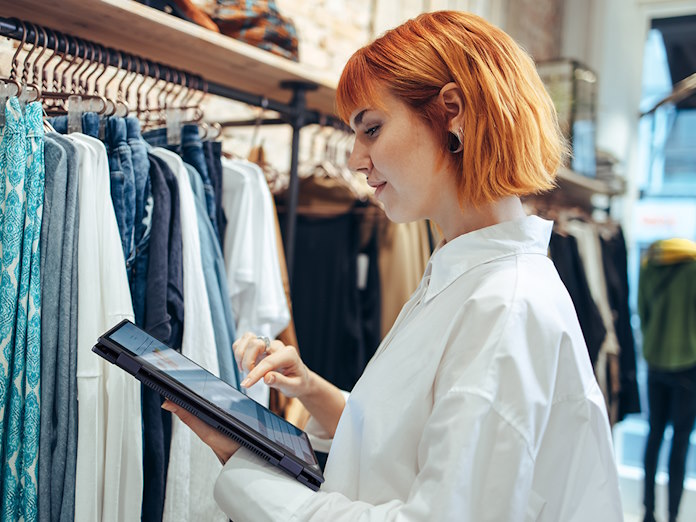 A young woman using an ASUS laptop in a retail store 