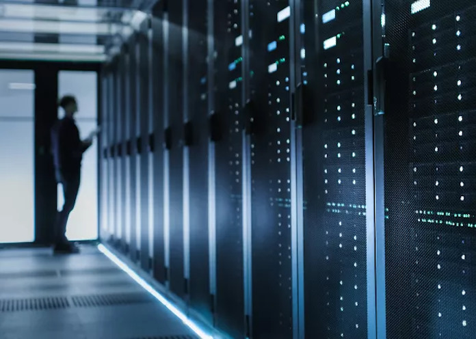 A man in a row of rack servers