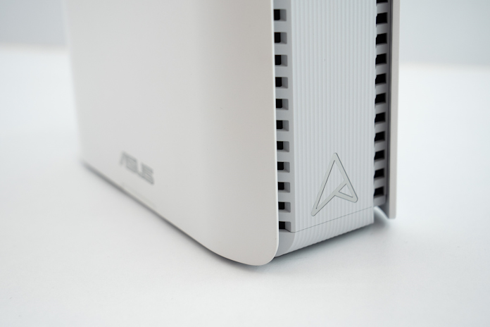 A closeup of the ASUS monogram logo on the ZenWiFi BE30000 mesh WiFi system