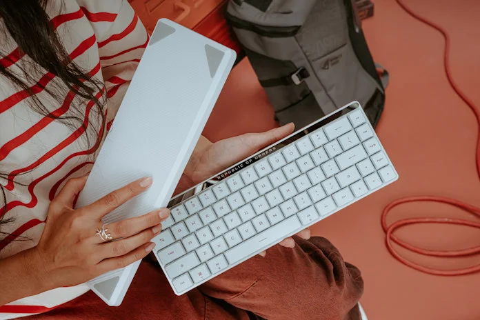 A young woman holding the ROG Falchion RX Low Profile and its travel case