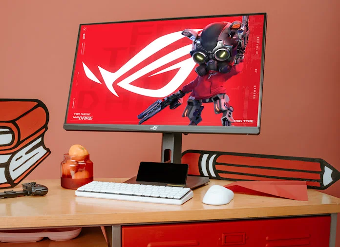 The ROG Strix XG27UCS gaming monitor on a student's desk with ROG peripherals in front