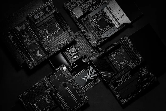 A selection of ASUS Z890 motherboard in a stack, with the central camera focus on the CPU socket of an ROG Z890 motherboard