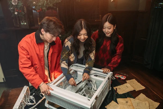 Three young people work on a PC build together