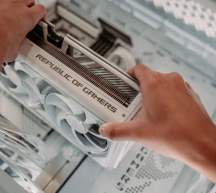 A closeup shot of a PC builder installing a graphics card