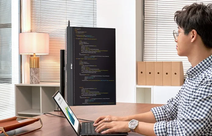 A man sworking on some coding using the ZenScreen MB229CF in portrait mode