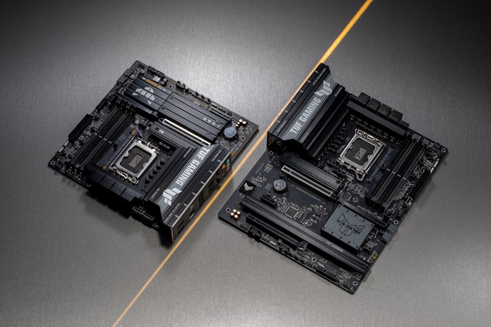 Two TUF Gaming B860 motherboards on a table separated by a yellow line