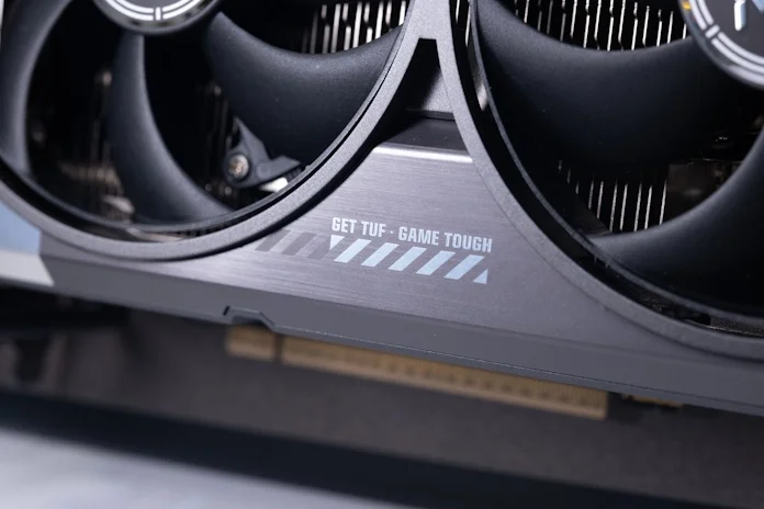 A logo on the face of the TUF Gaming GeForce RTX 5090 which reads "Get TUF - Game Tough"