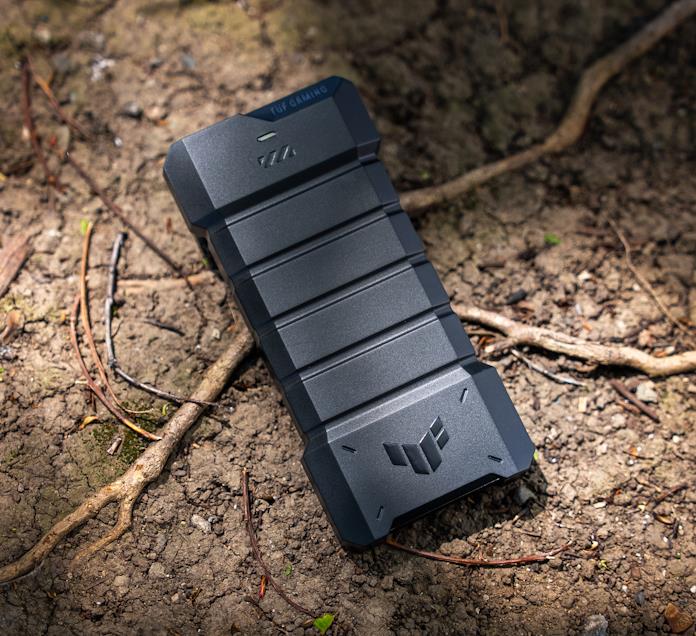 The TUF Gaming A2 portable SSD enclosure on a dry patch of ground