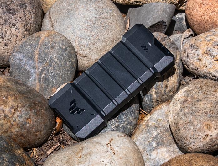 The TUF Gaming A2 portable SSD enclosure on a pile of rocks